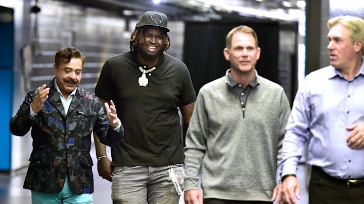 Jaguars owner Shad Khan talks with the team's first round draft pick Anton Harrison as they walk