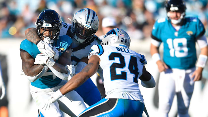 Jacksonville Jaguars running back Tank Bigsby (4) pushes through Carolina Panthers defenders on his