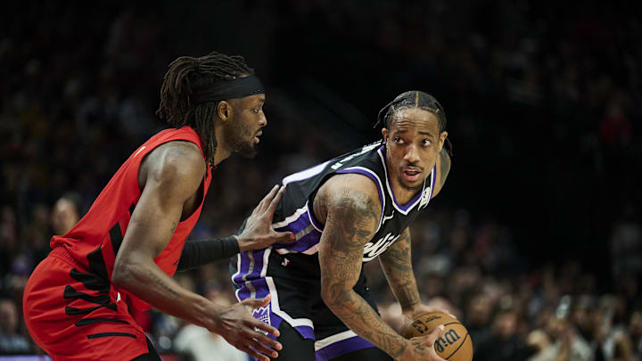 Feb 6, 2025; Portland, Oregon, USA; Sacramento Kings forward DeMar DeRozan (10) looks to pass the ball during the second half against Portland Trail Blazers forward Jerami Grant (9) at Moda Center. Mandatory Credit: Troy Wayrynen-Imagn Images