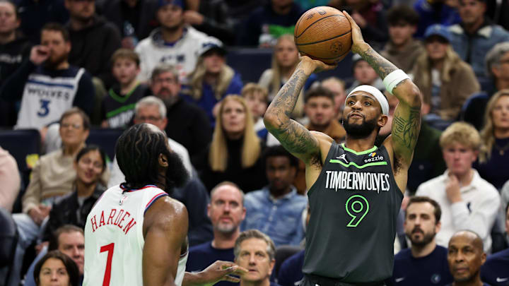 Nov 29, 2024; Minneapolis, Minnesota, USA; Minnesota Timberwolves guard Nickeil Alexander-Walker (9) shoots as LA Clippers guard James Harden (1) defends during the second half of an NBA Cup game at Target Center. Mandatory Credit: Matt Krohn-Imagn Images