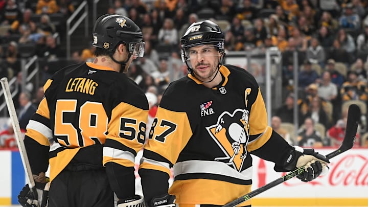 Jan 10, 2026; Pittsburgh, Pennsylvania, USA;  Pittsburgh Penguins center Sidney Crosby (87) and defenseman Kris Letang (58) talk during a break against the Calgary Flames during the third period at PPG Paints Arena. Mandatory Credit: Philip G. Pavely-Imagn Images