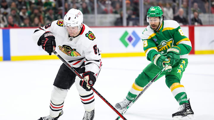 Dec 23, 2024; Saint Paul, Minnesota, USA; Chicago Blackhawks center Ryan Donato (8) skates with the puck as Minnesota Wild center Frederick Gaudreau (89) defends during the first period at Xcel Energy Center. Mandatory Credit: Matt Krohn-Imagn Images