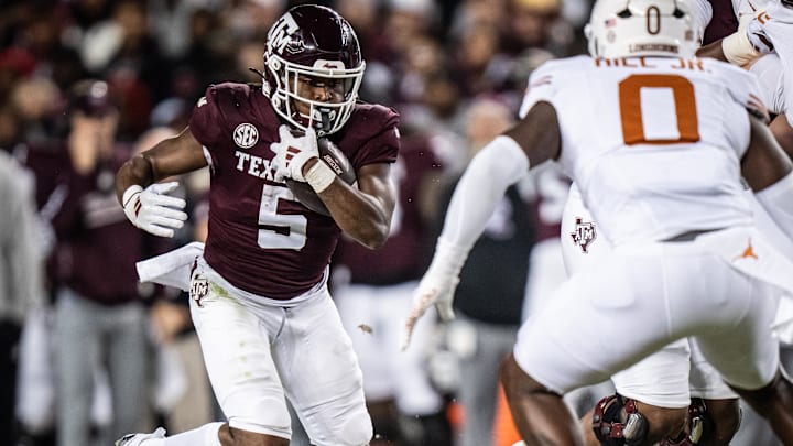 Nov 30, 2024; College Station, Texas, USA; Texas A&M Aggies running back Amari Daniels (5) carries the ball in the first quarter of the Lone Star Showdown against the Texas Longhorns at Kyle Field. Mandatory Credit: Sara Diggins/USA TODAY Network via Imagn Images Nov 30, 2024; College Station, Texas, USA; Texas A&M Aggies running back Amari Daniels (5) carries the ball in the first quarter of the Lone Star Showdown against the Texas Longhorns at Kyle Field. Mandatory Credit: Sara Diggins/USA TODAY Network via Imagn Images