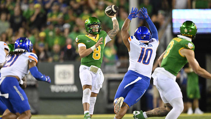 Sep 7, 2024; Eugene, Oregon, USA; Oregon Ducks quarterback Dillon Gabriel (8) passes the ball during the second half against Boise State Broncos linebacker Andrew Simpson (10) at Autzen Stadium. Mandatory Credit: Troy Wayrynen-Imagn Images