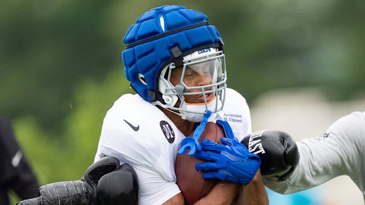 Indianapolis Colts running back Jonathan Taylor (28) secures the ball Monday, July 28, 2025, during training camp held at Grand Park in Westfield.