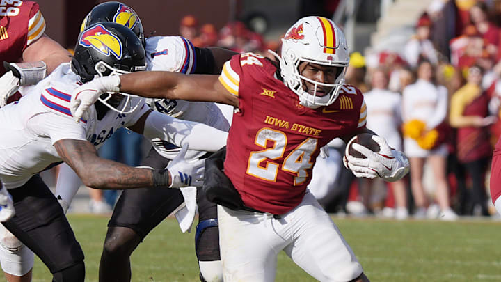 Iowa State Cyclones' running back Abu Sama III (24) breaks tackle from Kansas defenders as running for a first down during the fourth quarter in the senior day on Nov. 22, 2025, at Jack Trice Stadium in Ames, Iowa