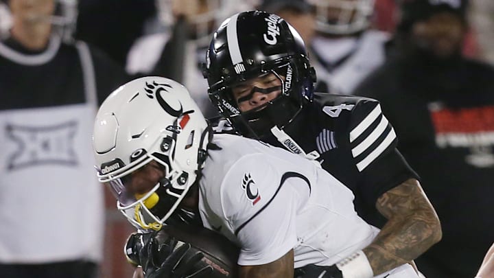 Iowa State Cyclones defensive back Jeremiah Cooper (4) takes down Cincinnati Bearcats' wide receiver Tony Johnson (0) during the first quarter in the week-12 NCAA football at Jack Trice Stadium on Saturday, Nov. 16, 2024, in Ames, Iowa.