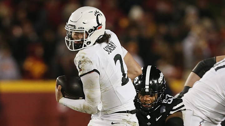 Cincinnati Bearcats' quarterback Brendan Sorsby (2) breaks a tackle from Iowa State Cyclones defensive line Zaimir Hawk (53) and runs for a firstdown during the third quarter in the week-12 NCAA football at Jack Trice Stadium on Saturday, Nov. 16, 2024, in Ames, Iowa. Cincinnati Bearcats' quarterback Brendan Sorsby (2) breaks a tackle from Iowa State Cyclones defensive line Zaimir Hawk (53) and runs for a firstdown during the third quarter in the week-12 NCAA football at Jack Trice Stadium on Saturday, Nov. 16, 2024, in Ames, Iowa.