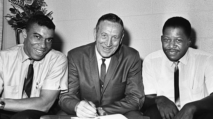 John Wooden, center, coach of the UCLA national champions, compares notes with his fellow basketball lecturers at Tennessee State's Blue Ribbon Clinic on July 23,1964. They are Harold Hunter, left, Tennessee State coach, and Cornelius Ridley of Pearl High School.