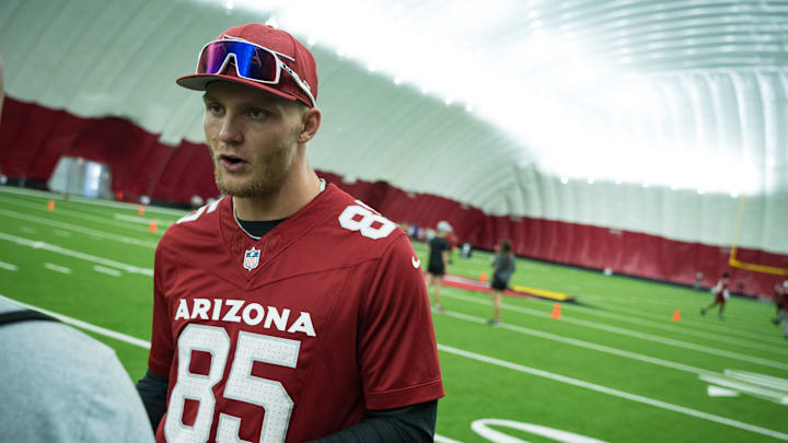 Tight end, Trey McBride speaks to a reporter during the girls flag football clinic at the Cardinals training facility on June 1, 2024 in Tempe, Ariz.