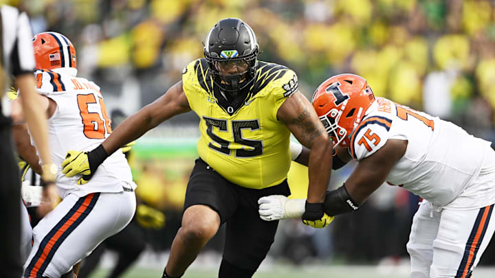 Oct 26, 2024; Eugene, Oregon, USA; Oregon Ducks defensive lineman Derrick Harmon (55) breaks past Illinois Fighting Illini offensive lineman Brandon Henderson (75) during the second half at Autzen Stadium. Mandatory Credit: Troy Wayrynen-Imagn Images