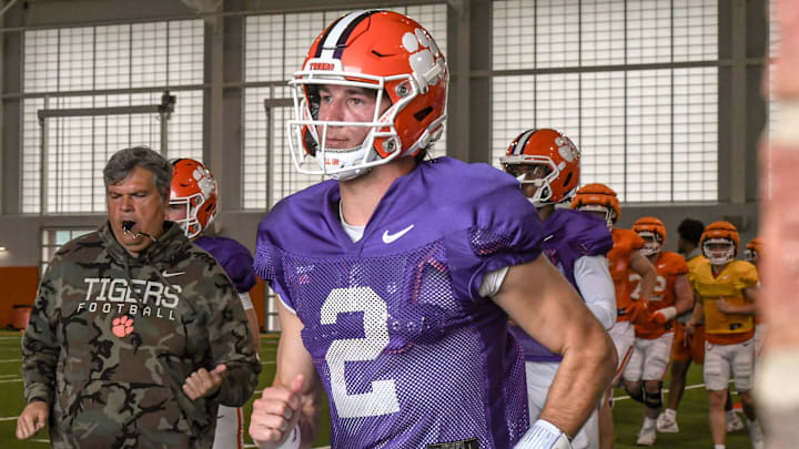 Clemson quarterback Cade Klubnik (2) runs to the outdoor fields with teammates and coaches during Spring Practice in Clemson, S.C. Monday, March 24, 2025.