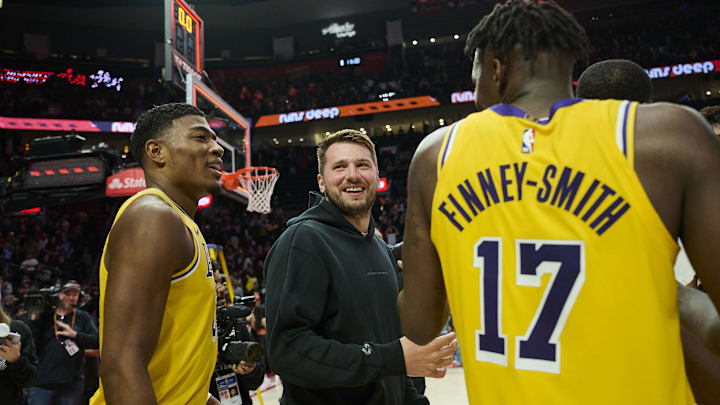 Feb 20, 2025; Portland, Oregon, USA; Los Angeles Lakers guard Luka Doncic (77) celebrates with forward Rui Hachimura (28) and forward Dorian Finney-Smith (17) after a game against the Portland Trail Blazers at Moda Center. Mandatory Credit: Troy Wayrynen-Imagn Images