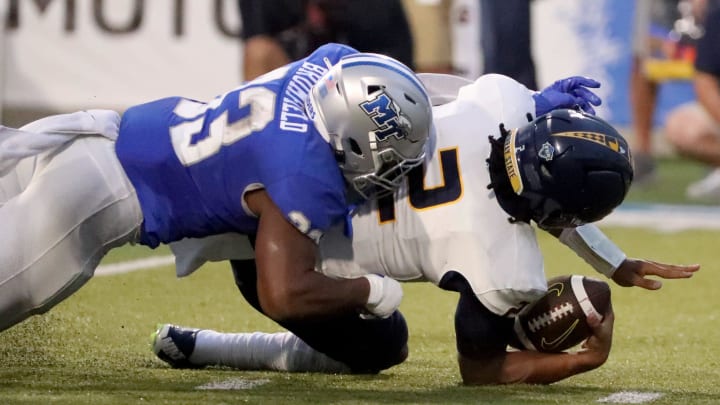 MTSU linebacker Sam Brumfield (33) sucks Murray State quarterback DJ Williams (2) during a football game at MTSU's Floyd Stadium on Saturday, Sept. 16, 2023. MTSU linebacker Sam Brumfield (33) sucks Murray State quarterback DJ Williams (2) during a football game at MTSU's Floyd Stadium on Saturday, Sept. 16, 2023.
