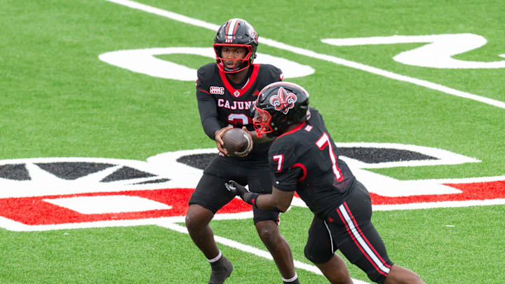 Nov. 29, 2025; Louisiana quarterback Lunch Winfield (2) hands off to running back Bill Davis (7). Nov. 29, 2025; Louisiana quarterback Lunch Winfield (2) hands off to running back Bill Davis (7).