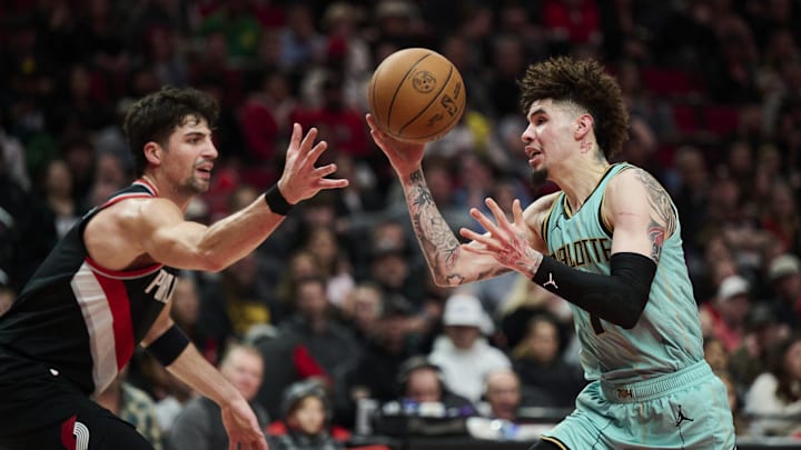 Feb 22, 2025; Portland, Oregon, USA; Charlotte Hornets guard LaMelo Ball (1) loses control of the basketball during the first half against Portland Trail Blazers forward Deni Avdija (8) at Moda Center. Mandatory Credit: Troy Wayrynen-Imagn Images