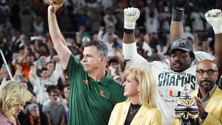 Miami Hurricanes head coach Mario Cristobal lifts the trophy after defeating Ole Miss 31-27 in the Vrbo Fiesta Bowl and CFP semifinal game at State Farm Stadium on Jan. 8, 2026, in Glendale.