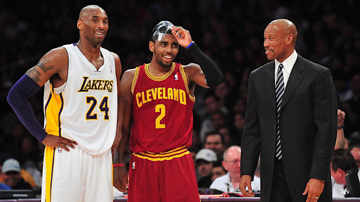 January 13, 2013; Los Angeles, CA, USA; Cleveland Cavaliers head coach Byron Scott speaks with point guard Kyrie Irving (2) and Los Angeles Lakers shooting guard Kobe Bryant (24)  during the first half at Staples Center. Mandatory Credit: Gary A. Vasquez-Imagn Images