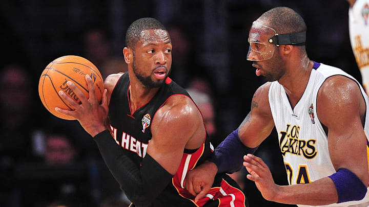 March 4, 2012; Los Angeles, CA, USA; Miami Heat shooting guard Dwyane Wade (3) controls the ball against the defense of Los Angeles Lakers shooting guard Kobe Bryant (24) during the second half at Staples Center. Mandatory Credit: Gary A. Vasquez-Imagn Images