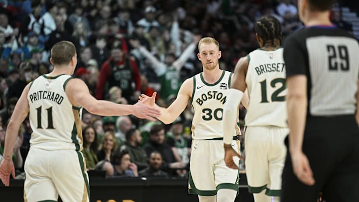 Mar 11, 2024; Portland, Oregon, USA; Boston Celtics forward Sam Hauser (30) celebrates with teammates guard Payton Pritchard (11), and forward Oshae Brissett (12) during the second half against the Portland Trail Blazers at Moda Center. Mandatory Credit: Troy Wayrynen-Imagn Images
