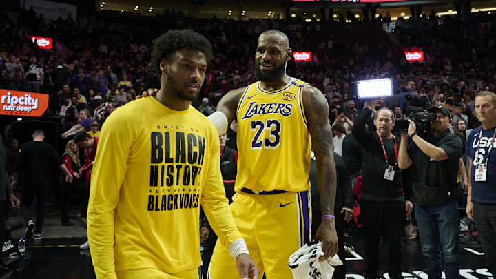 Feb 20, 2025; Portland, Oregon, USA; Los Angeles Lakers forward LeBron James (23) celebrates victory over the Portland Trail Blazers with his son guard Bronny James (9) at Moda Center. Mandatory Credit: Troy Wayrynen-Imagn Images