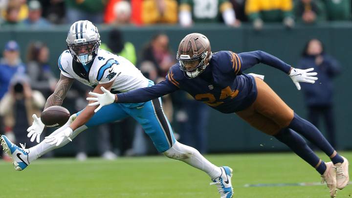 Green Bay Packers cornerback Carrington Valentine (24) breaks up a pass to Carolina Panthers wide receiver Tetairoa McMillan 