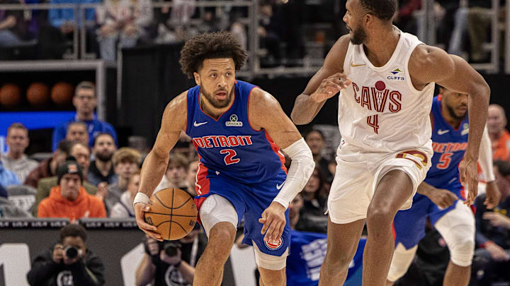 Feb 5, 2025; Detroit, Michigan, USA; Detroit Pistons guard Cade Cunningham (2) moves the ball up court on Cleveland Cavaliers forward Evan Mobley (4) during the first half at Little Caesars Arena. Mandatory Credit: David Reginek-Imagn Images