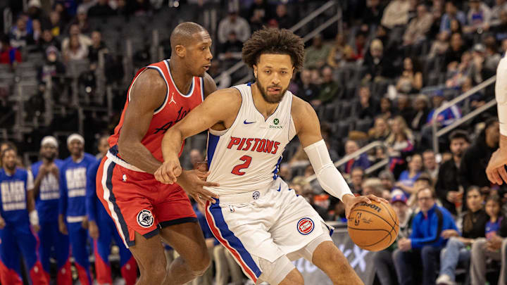 Feb 24, 2025; Detroit, Michigan, USA; Detroit Pistons guard Cade Cunningham (2) controls the ball in front of LA Clippers guard Kris Dunn (8) during the first half at Little Caesars Arena. Mandatory Credit: David Reginek-Imagn Images