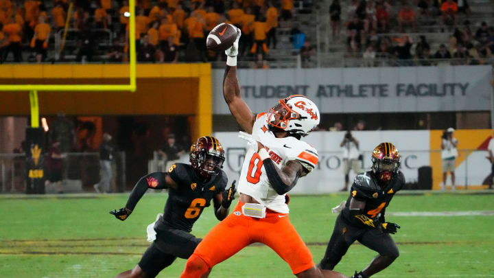 Oklahoma State Cowboys running back Ollie Gordon II (0) makes a one-handed catch against Arizona State Sun Devils defensive back Macen Williams (6) in the second half at Mountain America Stadium in Tempe on Sept. 9, 2023. Oklahoma State Cowboys running back Ollie Gordon II (0) makes a one-handed catch against Arizona State Sun Devils defensive back Macen Williams (6) in the second half at Mountain America Stadium in Tempe on Sept. 9, 2023.