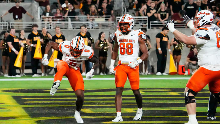 Oklahoma State Cowboys running back Ollie Gordon II (0) reacts after scoring a touchdown against the Arizona State Sun Devils in the first half at Mountain America Stadium in Tempe on Sept. 9, 2023. Oklahoma State Cowboys running back Ollie Gordon II (0) reacts after scoring a touchdown against the Arizona State Sun Devils in the first half at Mountain America Stadium in Tempe on Sept. 9, 2023.