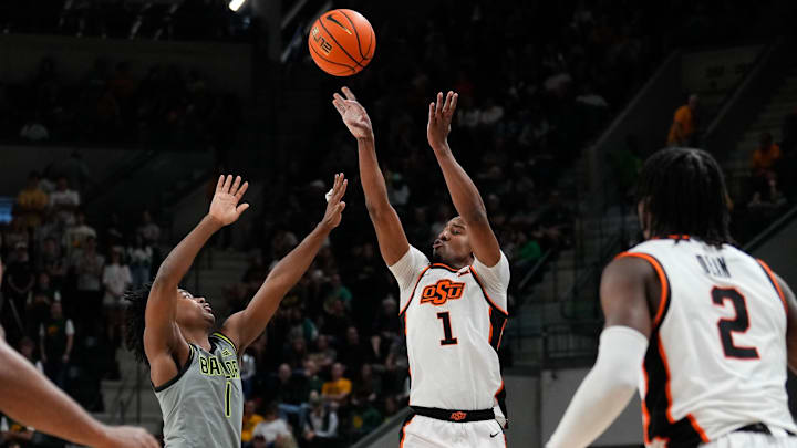 Mar 1, 2025; Waco, Texas, USA; Oklahoma State Cowboys guard Bryce Thompson (1) shoots as Baylor Bears guard Robert Wright III (1) defends during the first half at Paul and Alejandra Foster Pavilion. Mandatory Credit: Chris Jones-Imagn Images Mar 1, 2025; Waco, Texas, USA; Oklahoma State Cowboys guard Bryce Thompson (1) shoots as Baylor Bears guard Robert Wright III (1) defends during the first half at Paul and Alejandra Foster Pavilion. Mandatory Credit: Chris Jones-Imagn Images