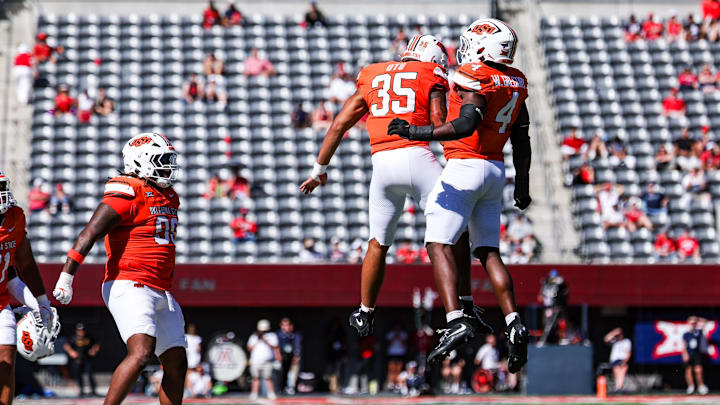 Oct 4, 2025; Tucson, Arizona, USA; Oklahoma State Cowboys outside linebacker Poasa Ute (35) and Wendell Gregory (4) celebrate during the third quarter of the game against the Arizona Wildcats at Arizona Stadium. Mandatory Credit: Aryanna Frank-Imagn Images