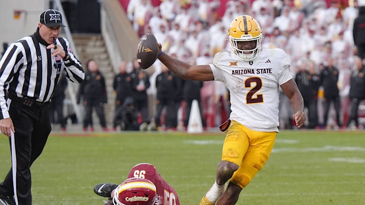 Arizona State Sun Devils quarterback Jeff Sims (2) breaks tackle from Iowa State Cyclones' defensive line Domonique Orange (95) and runs for a first down during the fourth quarter in the Big-12 showdown at jack Trice Stadium on Nov. 1, 2025, in Ames, Iowa.