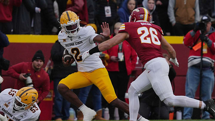 Arizona State Sun Devils quarterback Jeff Sims (2) battle for a few yards as Iowa State Cyclones' linebacker Caleb Bacon (26) attempts to tackle during the first quarter in the Big-12 showdown at jack Trice Stadium on Nov. 1, 2025, in Ames, Iowa.