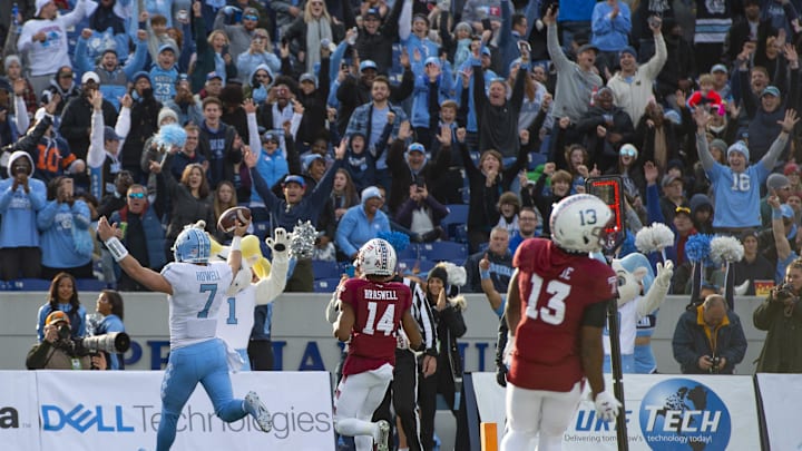 Dec 27, 2019; Annapolis, Maryland, USA;  North Carolina Tar Heels quarterback Sam Howell (7) reacts after catching a p[ass for a touchdown furring the third quarter as Temple Owls cornerback Christian Braswell (14) and  safety Ayron Monroe (13) look on at Navy-Marine Corps Memorial Stadium. 