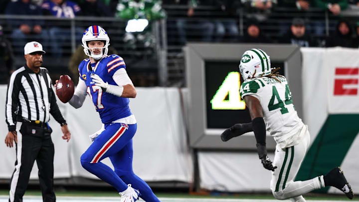 Oct 14, 2024; East Rutherford, New Jersey, USA; Buffalo Bills quarterback Josh Allen (17) looks to pass the ball while being chased by New York Jets linebacker Jamien Sherwood (44) during the second half at MetLife Stadium. Mandatory Credit: Ed Mulholland-Imagn Images