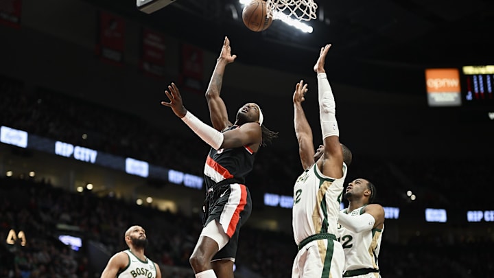 Mar 11, 2024; Portland, Oregon, USA; Portland Trail Blazers forward Jerami Grant (9) scores a basket during the first half against Boston Celtics center Al Horford (42) at Moda Center. Mandatory Credit: Troy Wayrynen-Imagn Images