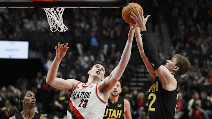 Oct 18, 2024; Portland, Oregon, USA; Portland Trail Blazers center Donovan Clingan (23) battles for a rebound during the second half against Utah Jazz forward Kyle Filipowski (22) at Moda Center. Mandatory Credit: Troy Wayrynen-Imagn Images Oct 18, 2024; Portland, Oregon, USA; Portland Trail Blazers center Donovan Clingan (23) battles for a rebound during the second half against Utah Jazz forward Kyle Filipowski (22) at Moda Center. Mandatory Credit: Troy Wayrynen-Imagn Images