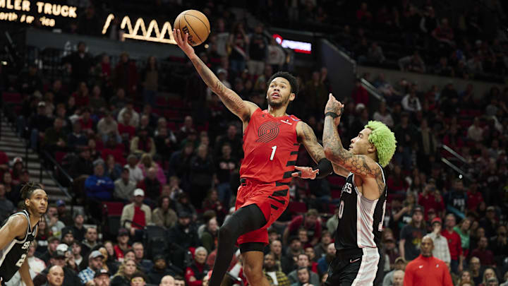 Dec 13, 2024; Portland, Oregon, USA; Portland Trail Blazers guard Anfernee Simons (1) scores a basket during the second half against San Antonio Spurs forward Jeremy Sochan (10) at Moda Center. Mandatory Credit: Troy Wayrynen-Imagn Images Dec 13, 2024; Portland, Oregon, USA; Portland Trail Blazers guard Anfernee Simons (1) scores a basket during the second half against San Antonio Spurs forward Jeremy Sochan (10) at Moda Center. Mandatory Credit: Troy Wayrynen-Imagn Images