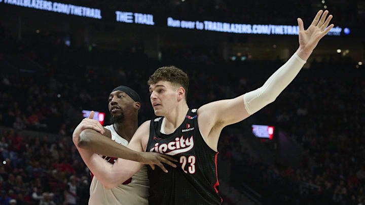 Jan 11, 2025; Portland, Oregon, USA; Portland Trail Blazers center Donovan Clingan (23) signals for the ball during the first half against Miami Heat center Bam Adebayo (13) at Moda Center. Mandatory Credit: Troy Wayrynen-Imagn Images