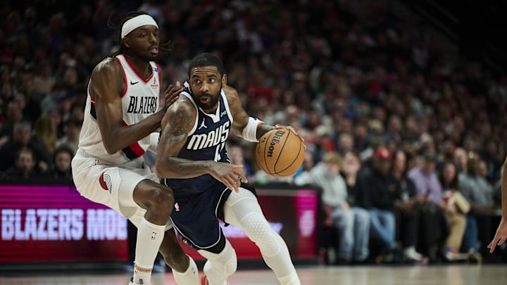 Dec 28, 2024; Portland, Oregon, USA; Dallas Mavericks guard Kyrie Irving (11) drives to the basket during the second half against Portland Trail Blazers forward Jerami Grant (9) at Moda Center. Mandatory Credit: Troy Wayrynen-Imagn Images