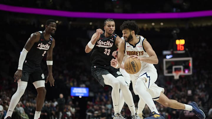 Dec 19, 2024; Portland, Oregon, USA; Denver Nuggets guard Jamal Murray (27) dribbles the ball during the second half against against Portland Trail Blazers forward Toumani Camara (33) at Moda Center. Mandatory Credit: Troy Wayrynen-Imagn Images