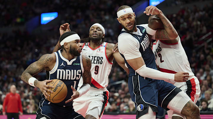 Dec 28, 2024; Portland, Oregon, USA; Dallas Mavericks guard Jaden Hardy (1) drives to the basket during the first half against Portland Trail Blazers forward Jerami Grant (9) as center Daniel Gafford (21) and center Deandre Ayton (2) vie for position at Moda Center. Mandatory Credit: Troy Wayrynen-Imagn Images