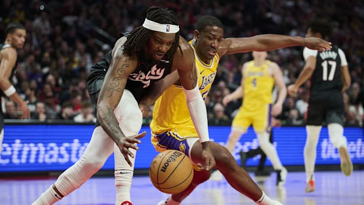 Feb 20, 2025; Portland, Oregon, USA; Portland Trail Blazers center Robert Williams III (35) and Los Angeles Lakers center Trey Jemison III (55) battle for control of a lose ball during the second half at Moda Center. Mandatory Credit: Troy Wayrynen-Imagn Images