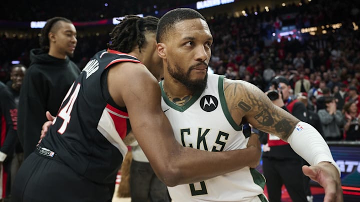 Jan 31, 2024; Portland, Oregon, USA; Milwaukee Bucks guard Damian Lillard (0) embraces Portland Trail Blazers forward Jabari Walker (34) after a game at Moda Center. Mandatory Credit: Troy Wayrynen-Imagn Images
