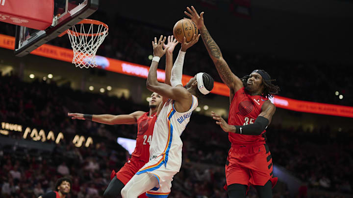 Jan 26, 2025; Portland, Oregon, USA; Portland Trail Blazers center Robert Williams III (35) blocks a shot during the second half against Oklahoma City Thunder guard Shai Gilgeous-Alexander (2) at Moda Center. Mandatory Credit: Troy Wayrynen-Imagn Images