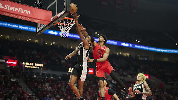 Dec 13, 2024; Portland, Oregon, USA; San Antonio Spurs guard Blake Wesley (14) is fouled during the first half by Portland Trail Blazers guard Scoot Henderson (00) at Moda Center. Mandatory Credit: Troy Wayrynen-Imagn Images Dec 13, 2024; Portland, Oregon, USA; San Antonio Spurs guard Blake Wesley (14) is fouled during the first half by Portland Trail Blazers guard Scoot Henderson (00) at Moda Center. Mandatory Credit: Troy Wayrynen-Imagn Images