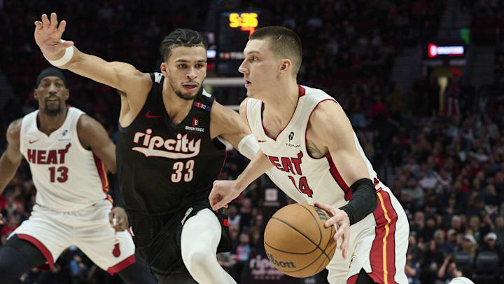 Jan 11, 2025; Portland, Oregon, USA; Miami Heat guard Tyler Herro (14) drives to the basket during the second half against Portland Trail Blazers forward Toumani Camara (33) at Moda Center. Mandatory Credit: Troy Wayrynen-Imagn Images
