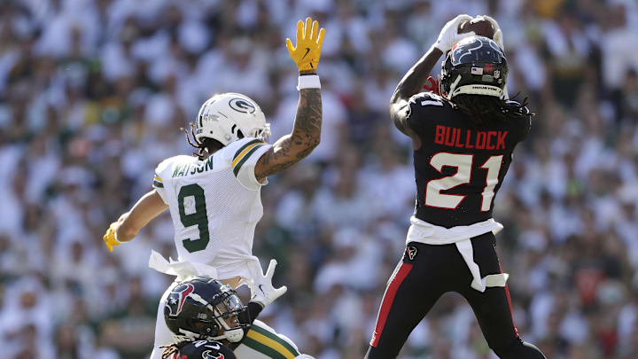 Oct 20, 2024; Green Bay, Wisconsin, USA; Houston Texans safety Calen Bullock (21) intercepts a pass to Green Bay Packers wide receiver Christian Watson (9)  at Lambeau Field. Mandatory Credit: William Glasheen/Appleton Post-Crescent via the USA TODAY NETWORK-Wisconsin-Imagn Images