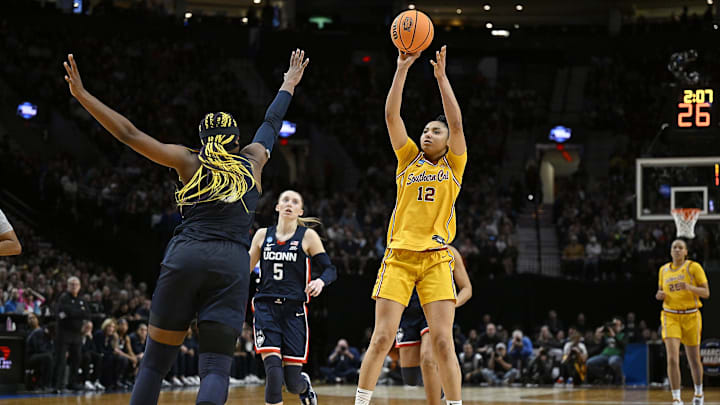 Apr 1, 2024; Portland, OR, USA; USC Trojans guard JuJu Watkins (12) shoots a jump shot during the second half against UConn Huskies forward Aaliyah Edwards (3) in the finals of the Portland Regional of the NCAA Tournament at the Moda Center. Mandatory Credit: Troy Wayrynen-Imagn Images